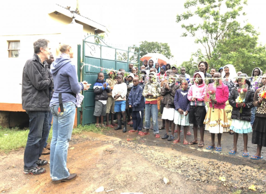 We cut the welcome ribbon while the children and shared flowers with us.